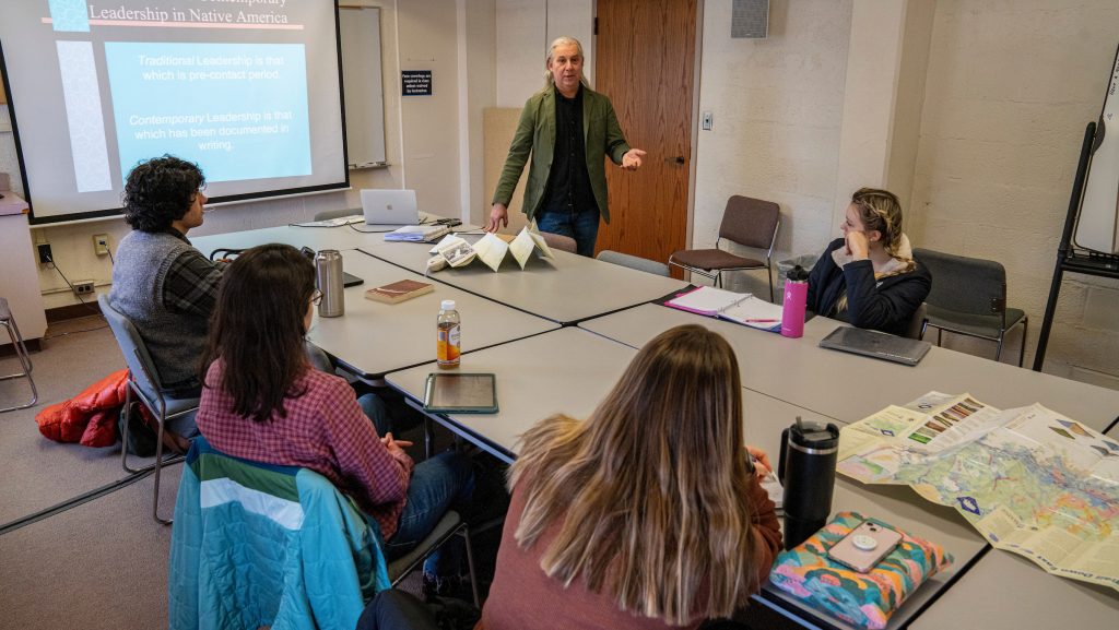 A photo of John Bear Mitchell teaching a lecture