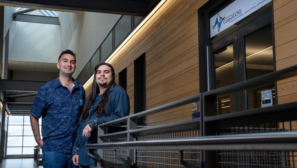 A photo of two people standing outside a lab